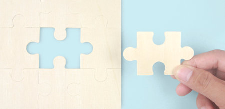 Connecting jigsaw puzzle in a hand. Business solutions success and strategy conceptの写真素材