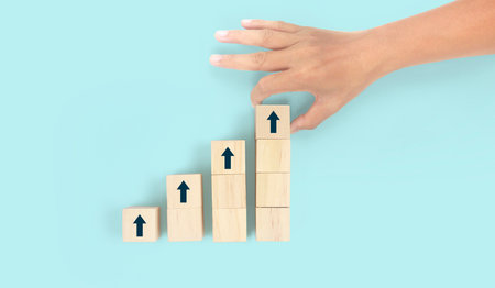 Business connecting piece of multi wood chart blocks steps in a handの写真素材