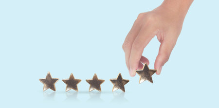 Rise on increasing five stars in human hand, Increase ratingの写真素材