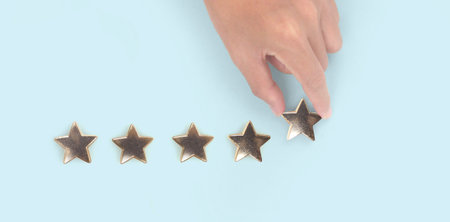 Rise on increasing five stars in human hand, Increase ratingの写真素材