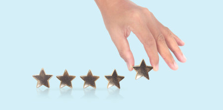 Rise on increasing five stars in human hand, Increase ratingの写真素材