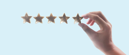 Rise on increasing five stars in human hand, Increase ratingの写真素材