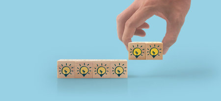Wooden cubes in a hand with copy space for input wordingの写真素材