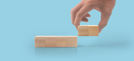 Wooden cubes in a hand with copy space for input wordingの写真素材