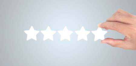 Rise on increasing five stars in human hand, Increase ratingの写真素材