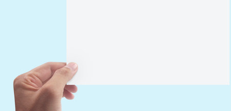 Hands holding paper blank for a letter paperの写真素材