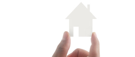 Hands holding paper house, family home and protecting insurance conceptの写真素材