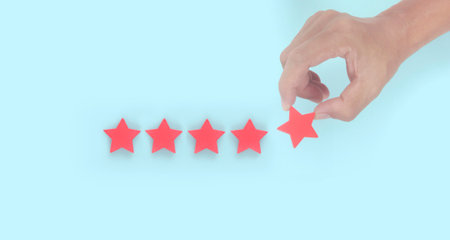 Rise on increasing five stars in human hand, Increase rating evaluation classification conceptの写真素材