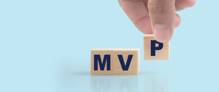 Wooden cube in hand with the letter from the mvp word . wooden cubes standingの写真素材