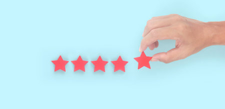 Rise on increasing five stars in human hand, Increase rating evaluation classification conceptの写真素材