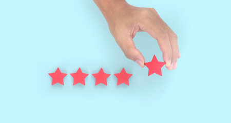 Rise on increasing five stars in human hand, Increase rating evaluation classification conceptの写真素材