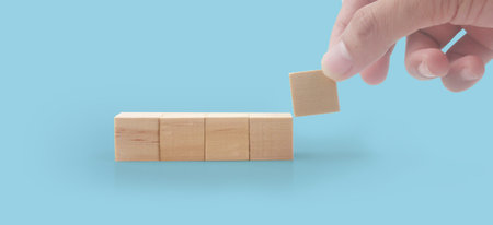Wooden cubes in hand with copy space for input wording and infographicの写真素材