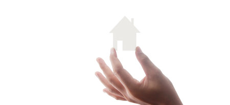 Hands holding paper house, family home and protecting insurance conceptの写真素材