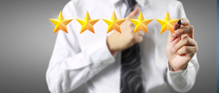 Rise on increasing five stars in human hand, Increase ratingの写真素材