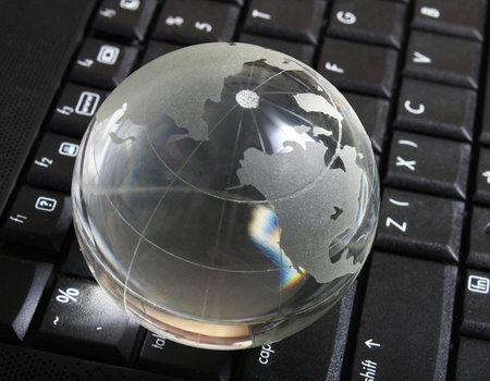 Globe on keyboard in  officeの写真素材