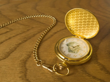 Luxurious golden watch on the wooden backgroundの写真素材