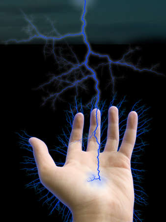Hand and lightning on black backgroundの写真素材