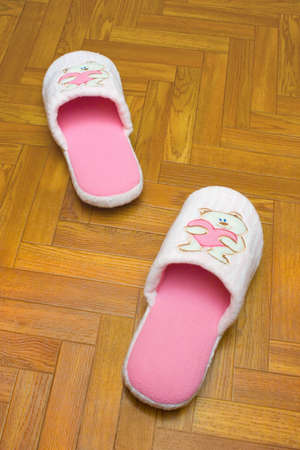 Childlike slippers on parquet, bear with (one step)の写真素材
