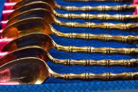 Gold spoons in box, retro backgroundの写真素材