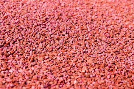 Closeup of red gravel texture, abstract backgroundの写真素材