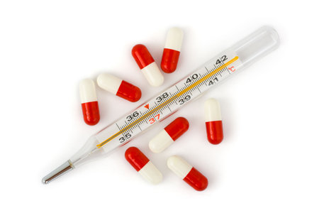 Isolated thermometer and pills - abstract medical backgroundの写真素材