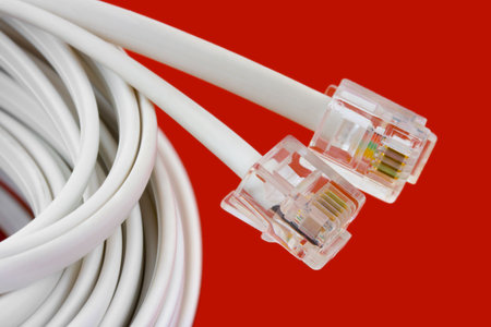 Macro of telephone cable isolated on red background
