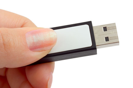 Flash drive in hand isolated on white background