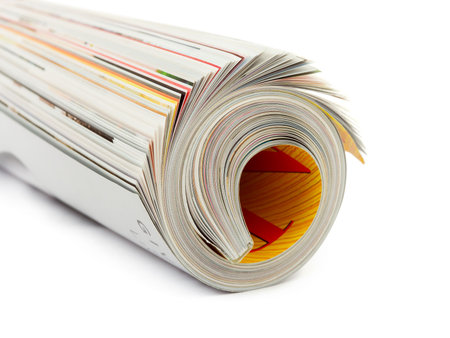 Roll of magazine isolated on white backgroundの写真素材