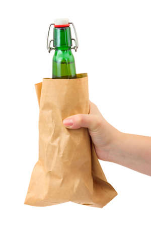 Hand and beer bottle in paper packet isolated on white backgroundの写真素材