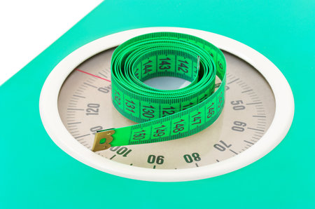 Measuring tape on weight scale, health slimming background