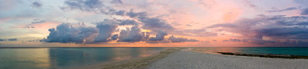 Ocean, beach and sunset, panorama made of 12 framesの写真素材