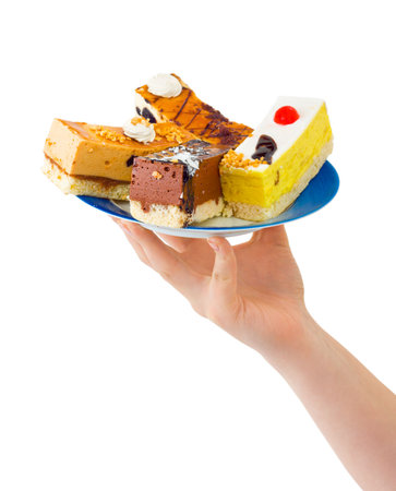 Hand giving plate with cakes isolated on white background