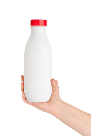 Hand with milk bottle isolated on white backgroundの写真素材