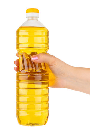Hand with bottle of cooking oil isolated on white backgroundの写真素材