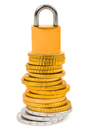 Stack of coins and lock isolated on white backgroundの写真素材
