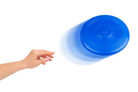 Hand and flying disc isolated on white backgroundの写真素材
