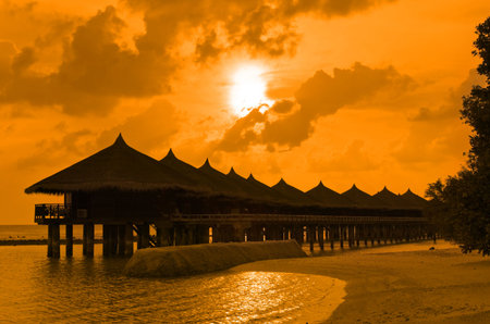 Water bungalows and sunset - abstract vacation backgroundのeditorial素材