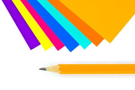Multicolored paper and pencil isolated on white backgroundの写真素材