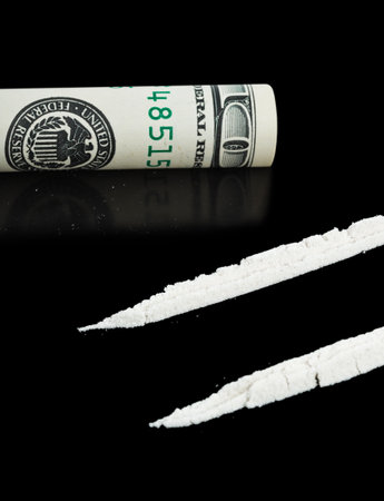 Cocaine and money isolated on black backgroundの写真素材