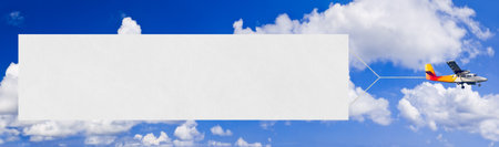 Flying airplane and banner, sky on backgroundの写真素材