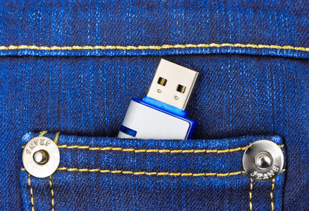 Flash memory in jeans pocket - technology background