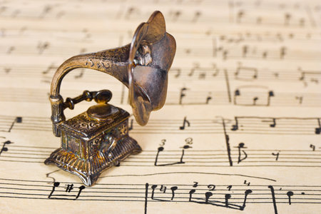 Gramophone on old sheet music - retro art backgroundの写真素材