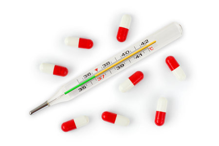 Isolated thermometer and pills - abstract medical backgroundの写真素材