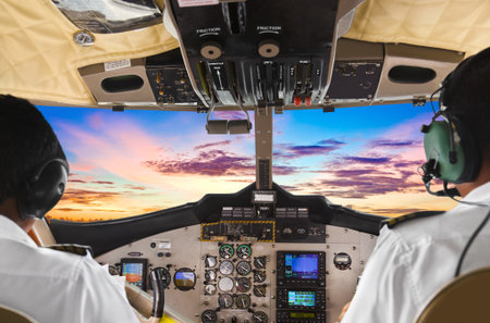 Pilots in the plane cockpit and sunsetの写真素材