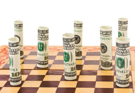 Money on chess board isolated on white background Money on chess board isolated on white background