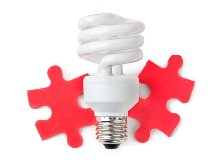 Lamp and red puzzle isolated on white background
