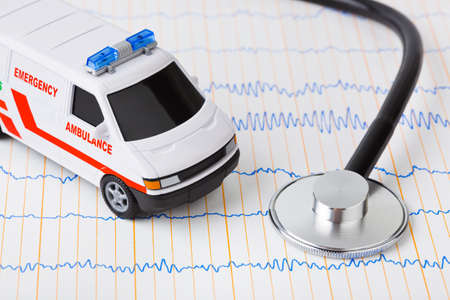 Stethoscope and ambulance car on ecg - medical backgroundの写真素材