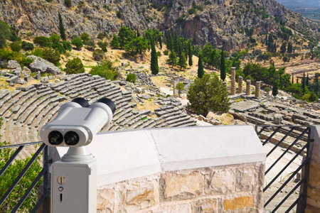 Binoculars and ancient city Delphi, Greece - archaeology background