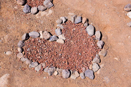 Heart made of stones on beach の写真素材