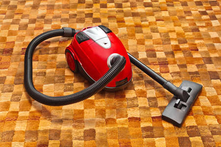Vacuum cleaner on carpet - technology houseworkの写真素材